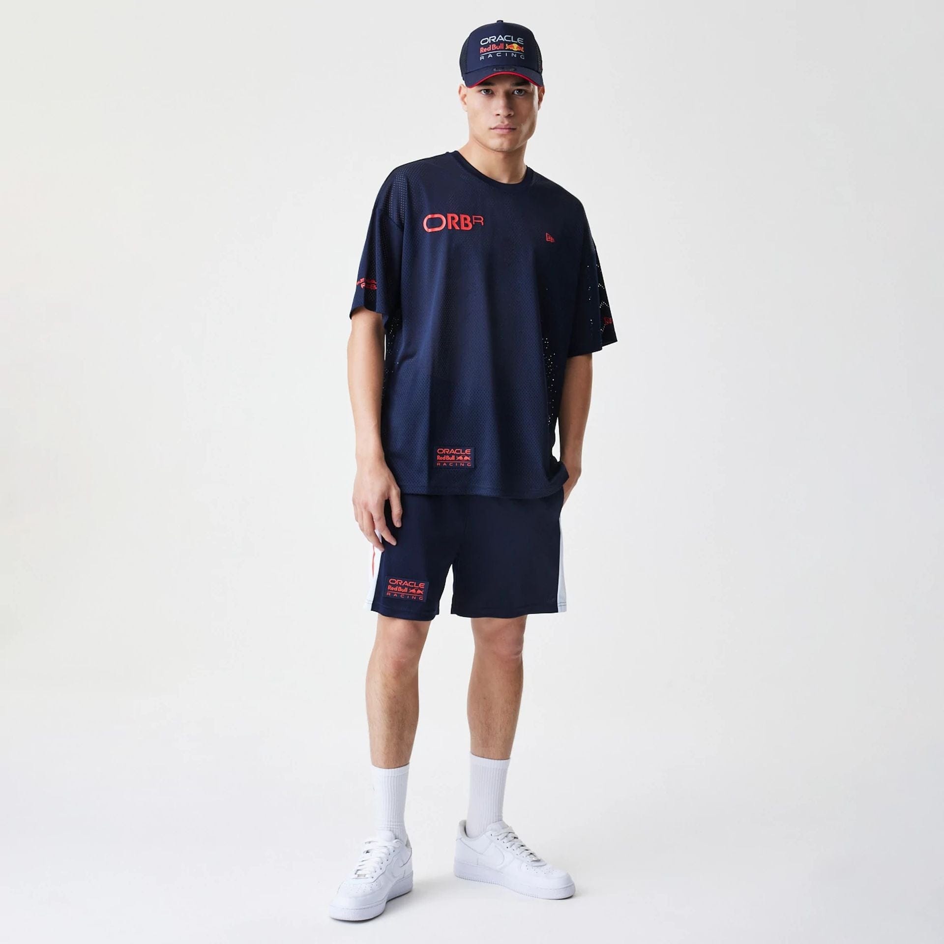 The Male model is wearing Red Bull Racing Graphic Mesh Dark Blue Oversized T-Shirt 8