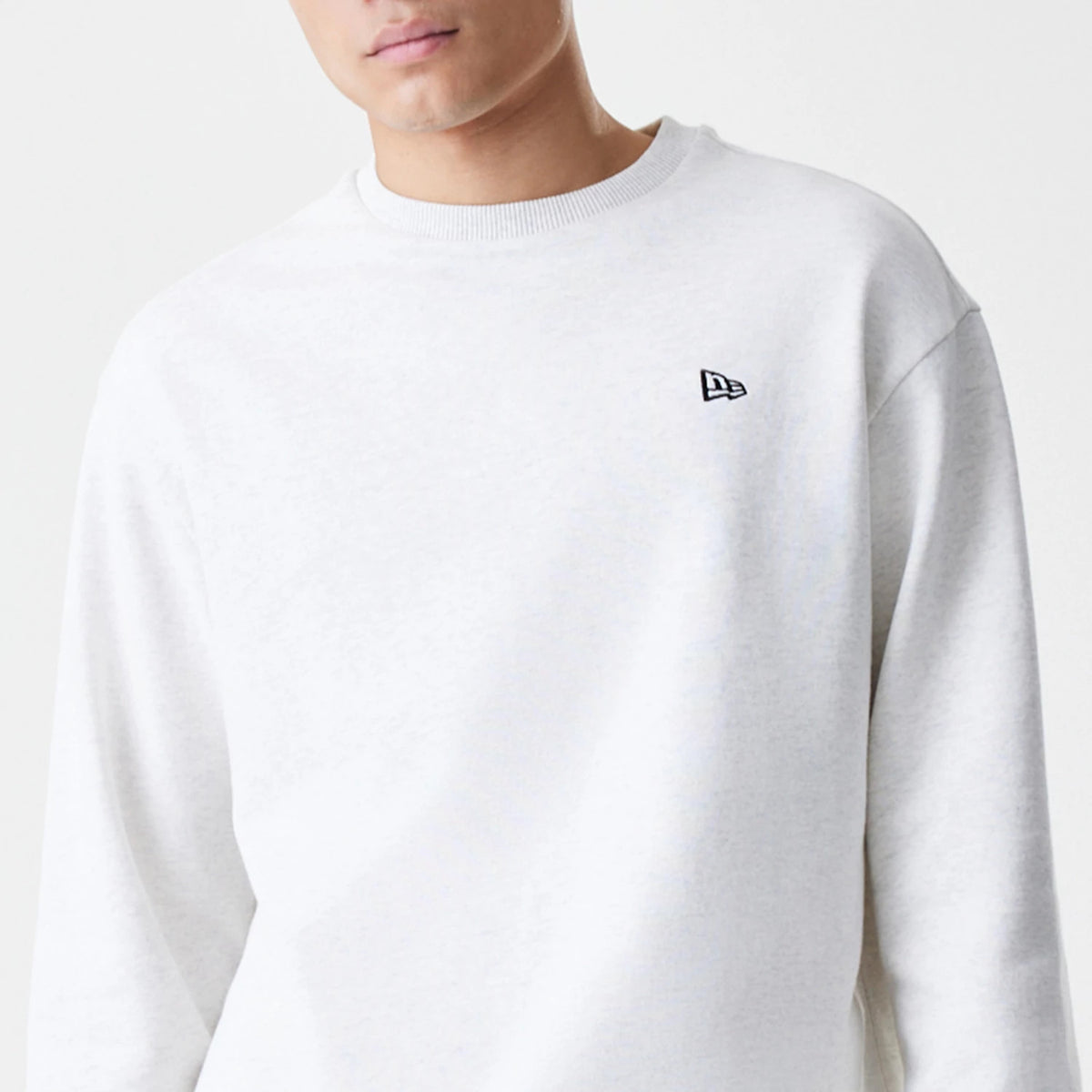 The Male model is wearing New Era Premium Essential Pastel Grey Oversized Crew Neck Sweater 3