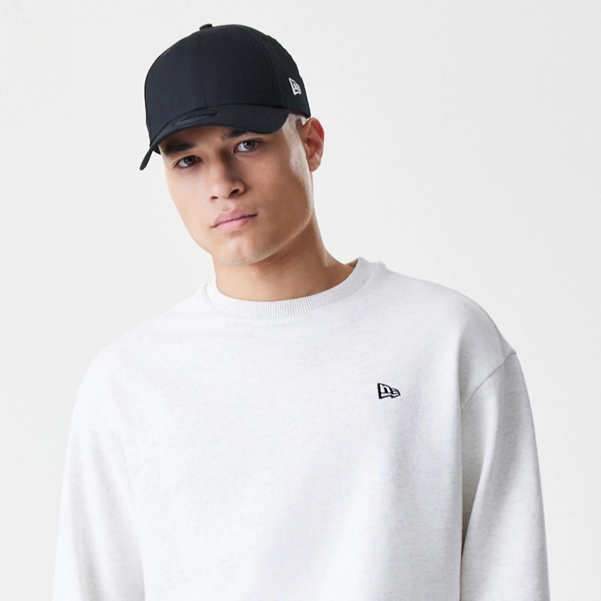 The Male model is wearing New Era Premium Essential Pastel Grey Oversized Crew Neck Sweater 6