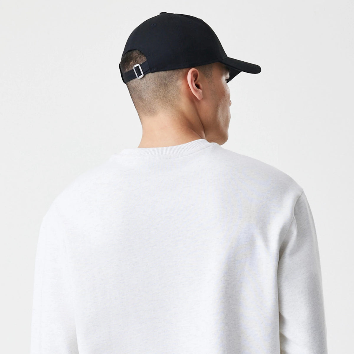 The Male model is wearing New Era Premium Essential Pastel Grey Oversized Crew Neck Sweater 7