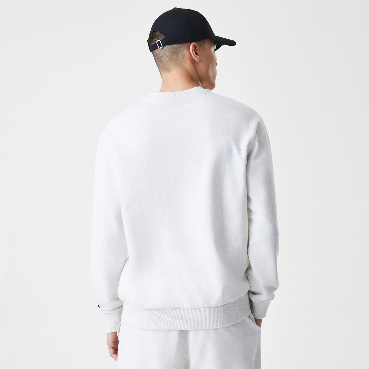 The Male model is wearing New Era Premium Essential Pastel Grey Oversized Crew Neck Sweater 2