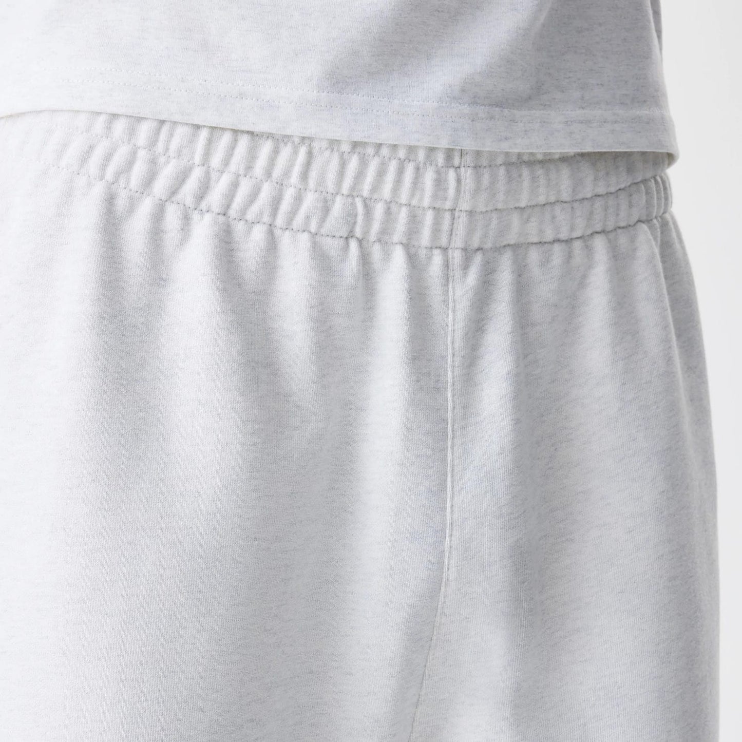 The Male model is wearing New Era Premium Essential Pastel Grey Joggers 6