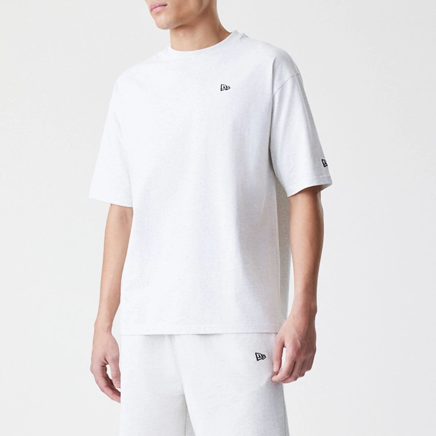 The Male model is wearing New Era Premium Essential Pastel Grey Oversized T-Shirt 3