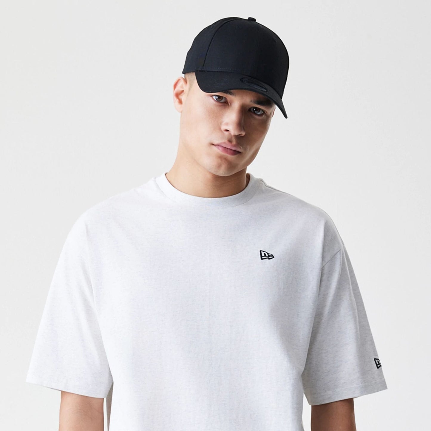 The Male model is wearing New Era Premium Essential Pastel Grey Oversized T-Shirt 6