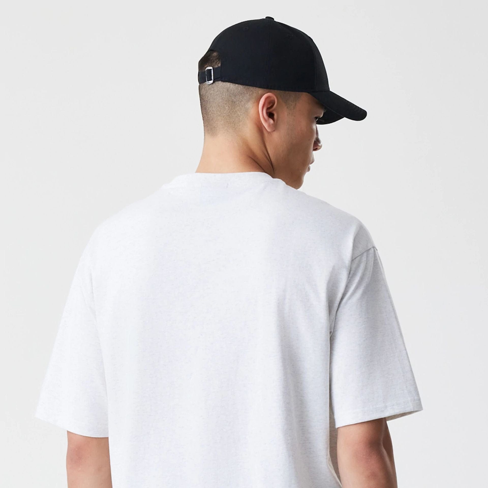 The Male model is wearing New Era Premium Essential Pastel Grey Oversized T-Shirt 7