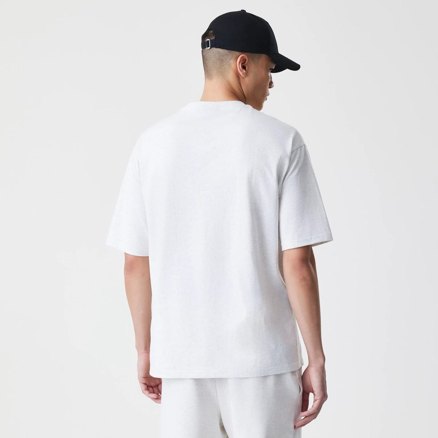 The Male model is wearing New Era Premium Essential Pastel Grey Oversized T-Shirt 2