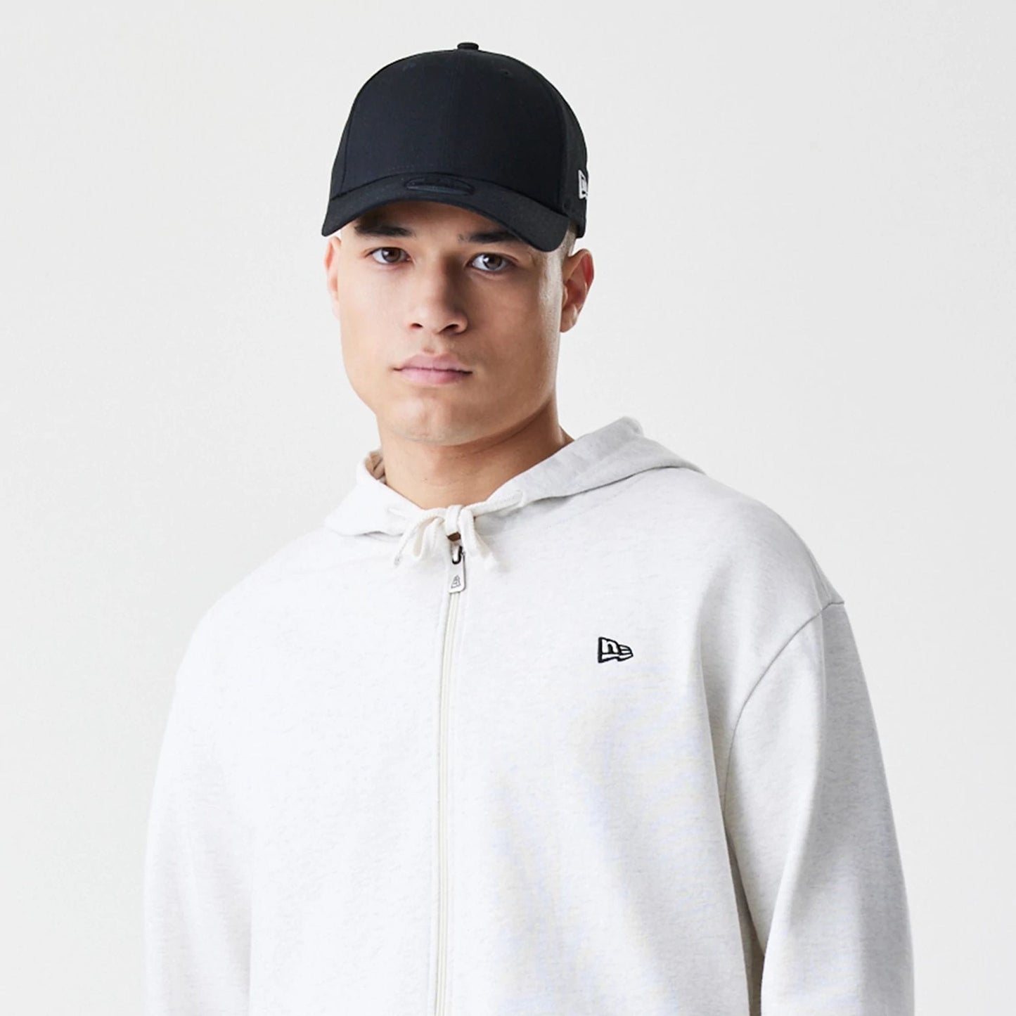 The Male model is wearing New Era Premium Essential Pastel Grey Oversized Full Zip Hoodie 6