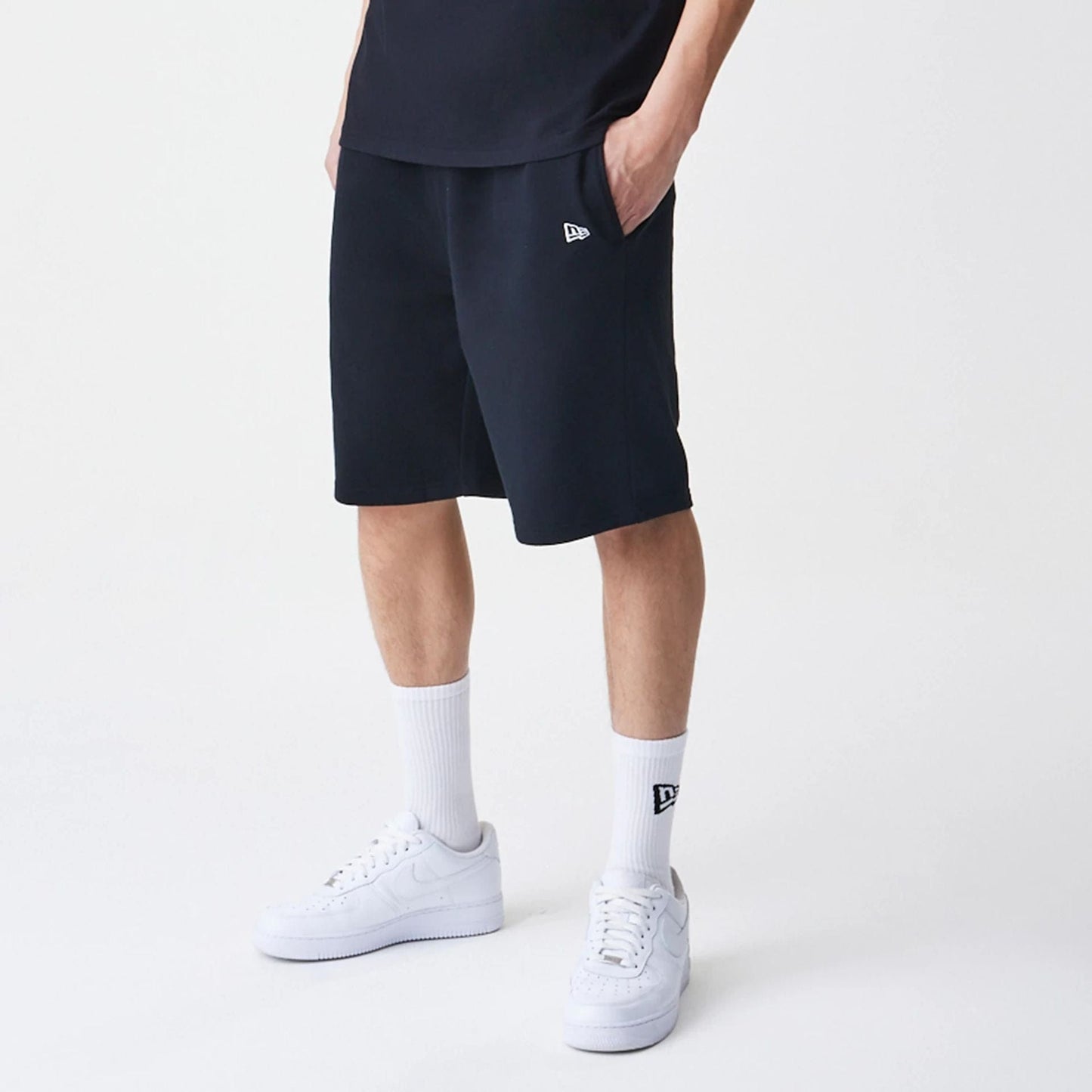 The Male model is wearing New Era Premium Essential Black Oversized Shorts 3