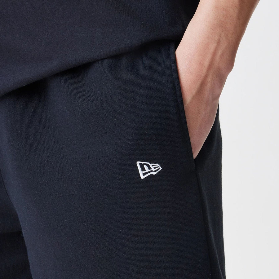 The Male model is wearing New Era Premium Essential Black Oversized Shorts 5