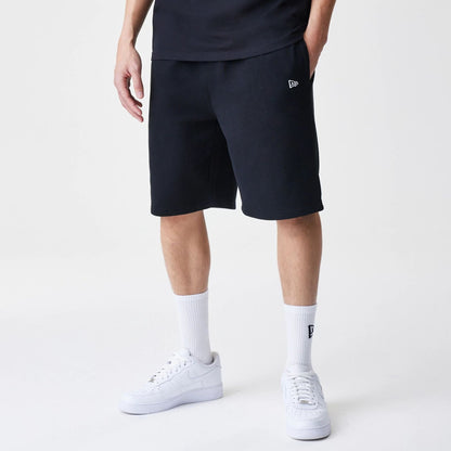 The Male model is wearing New Era Premium Essential Black Oversized Shorts 1