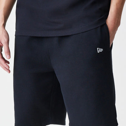 The Male model is wearing New Era Premium Essential Black Oversized Shorts 6