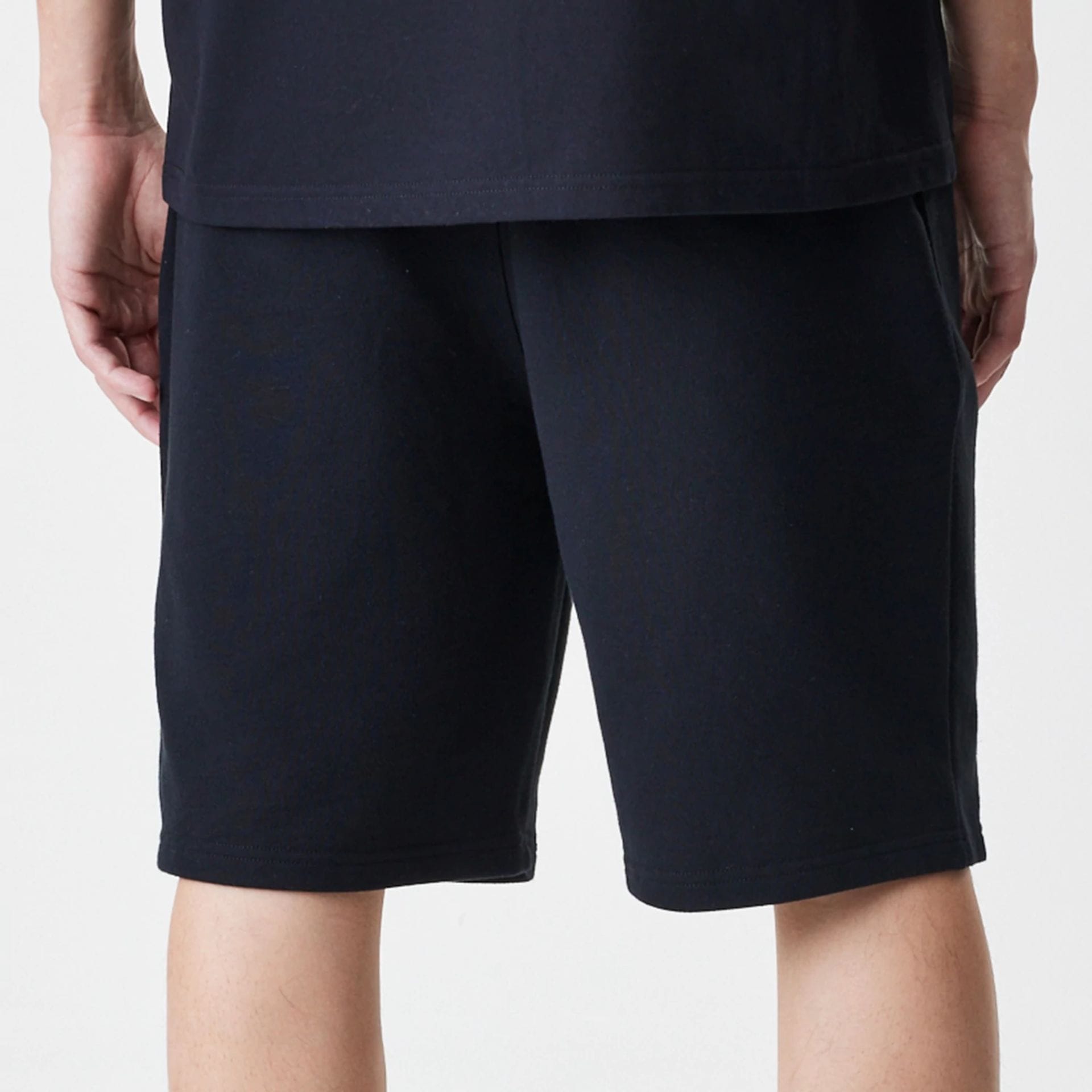 The Male model is wearing New Era Premium Essential Black Oversized Shorts 7