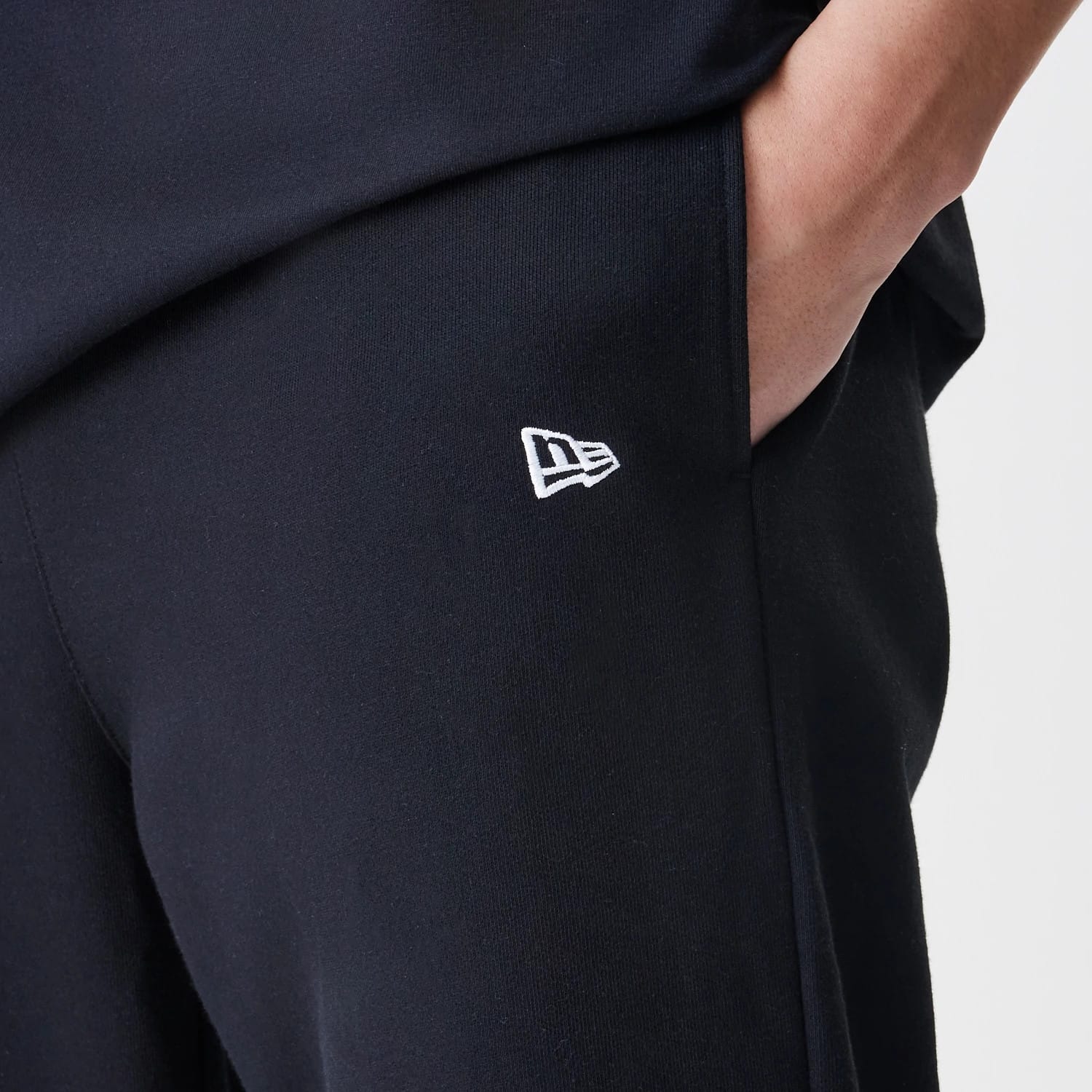 The Male model is wearing New Era Premium Essential Black Joggers 5