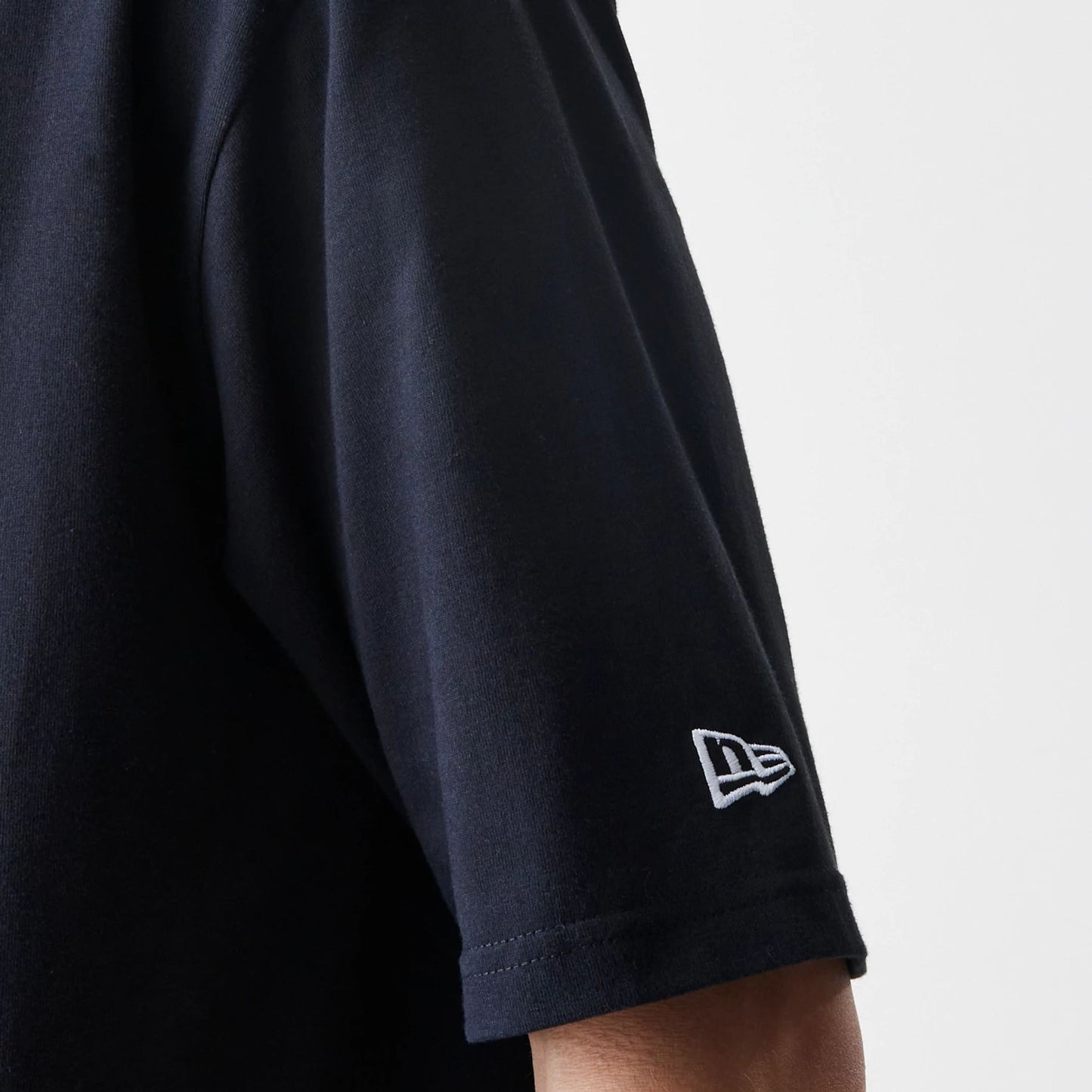 The Male model is wearing New Era Premium Essential Black Oversized T-Shirt 5