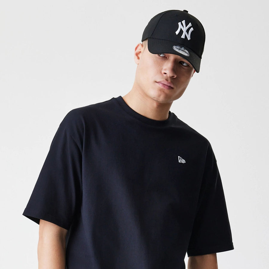 The Male model is wearing New Era Premium Essential Black Oversized T-Shirt 6