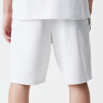 The Male model is wearing New Era Premium Essential Pastel Grey Oversized Shorts 7