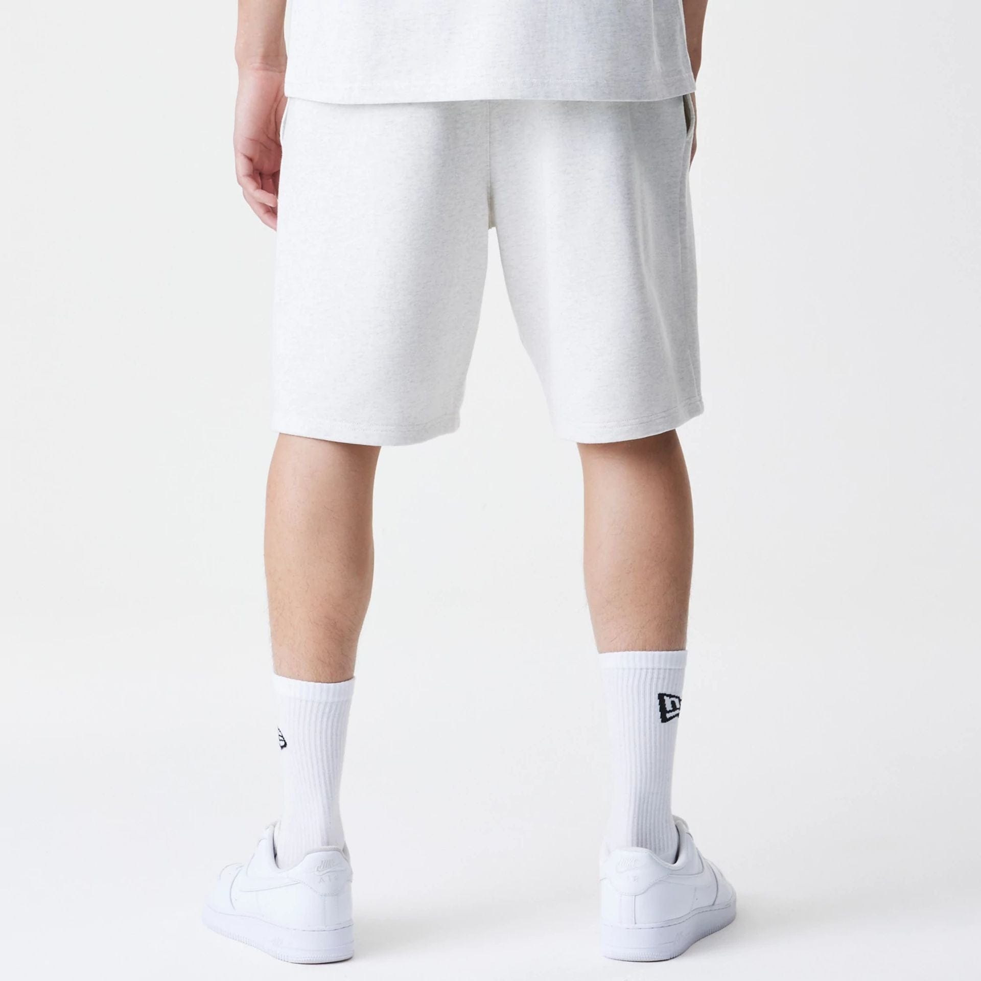 The Male model is wearing New Era Premium Essential Pastel Grey Oversized Shorts 2