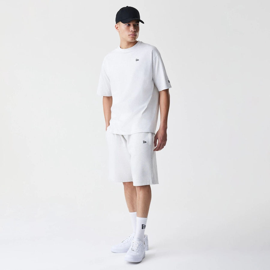 The Male model is wearing New Era Premium Essential Pastel Grey Oversized Shorts 8