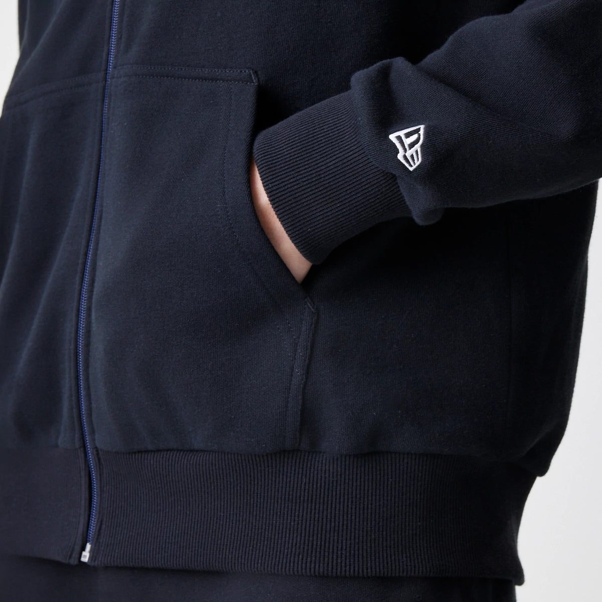 The Male model is wearing New Era Premium Essential Black Oversized Full Zip Hoodie 5
