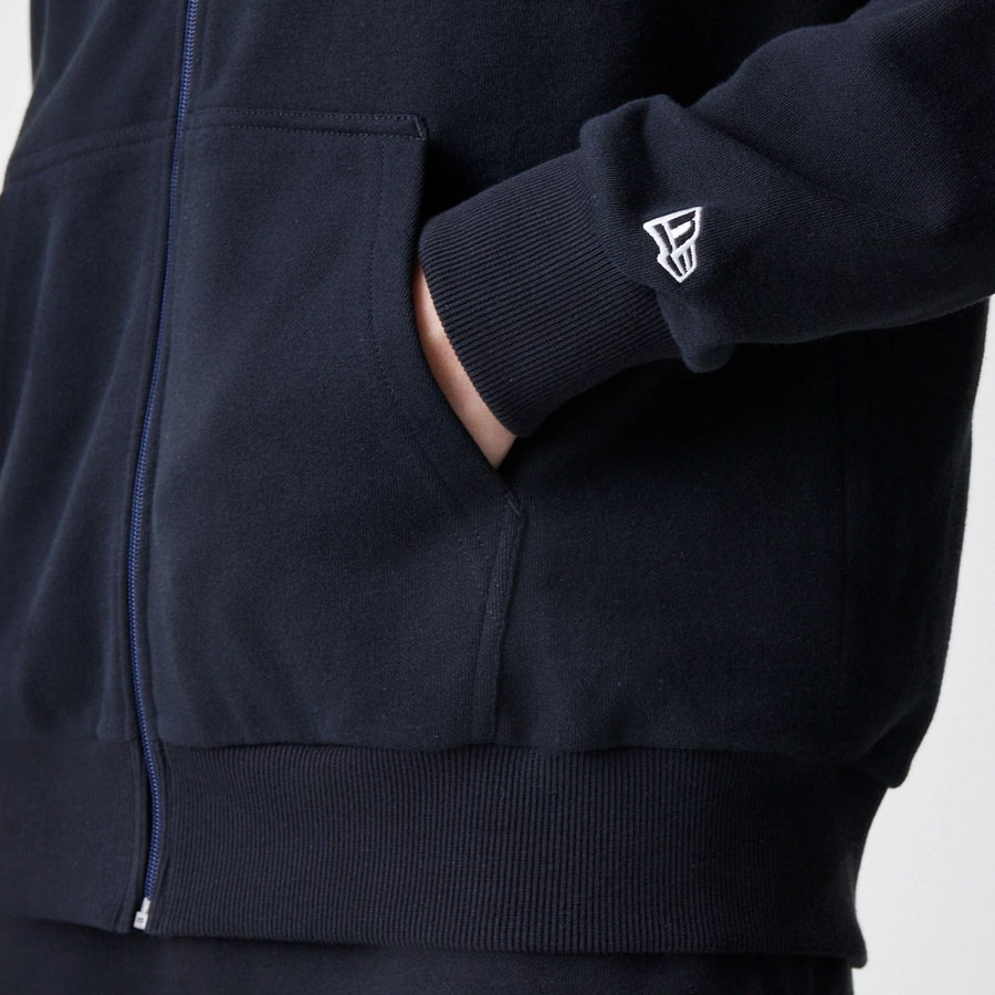 The Male model is wearing New Era Premium Essential Black Oversized Full Zip Hoodie 5