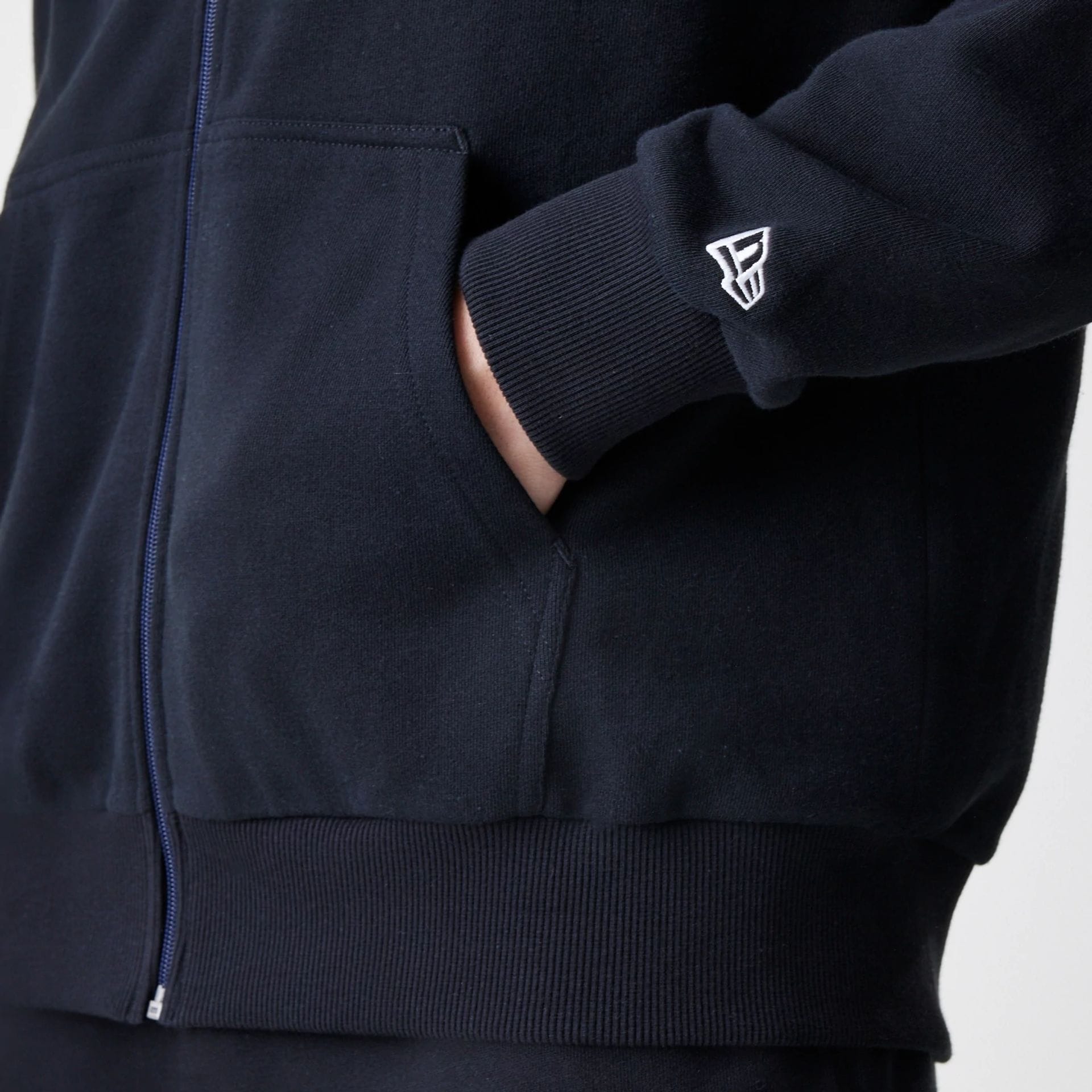 The Male model is wearing New Era Premium Essential Black Oversized Full Zip Hoodie 5