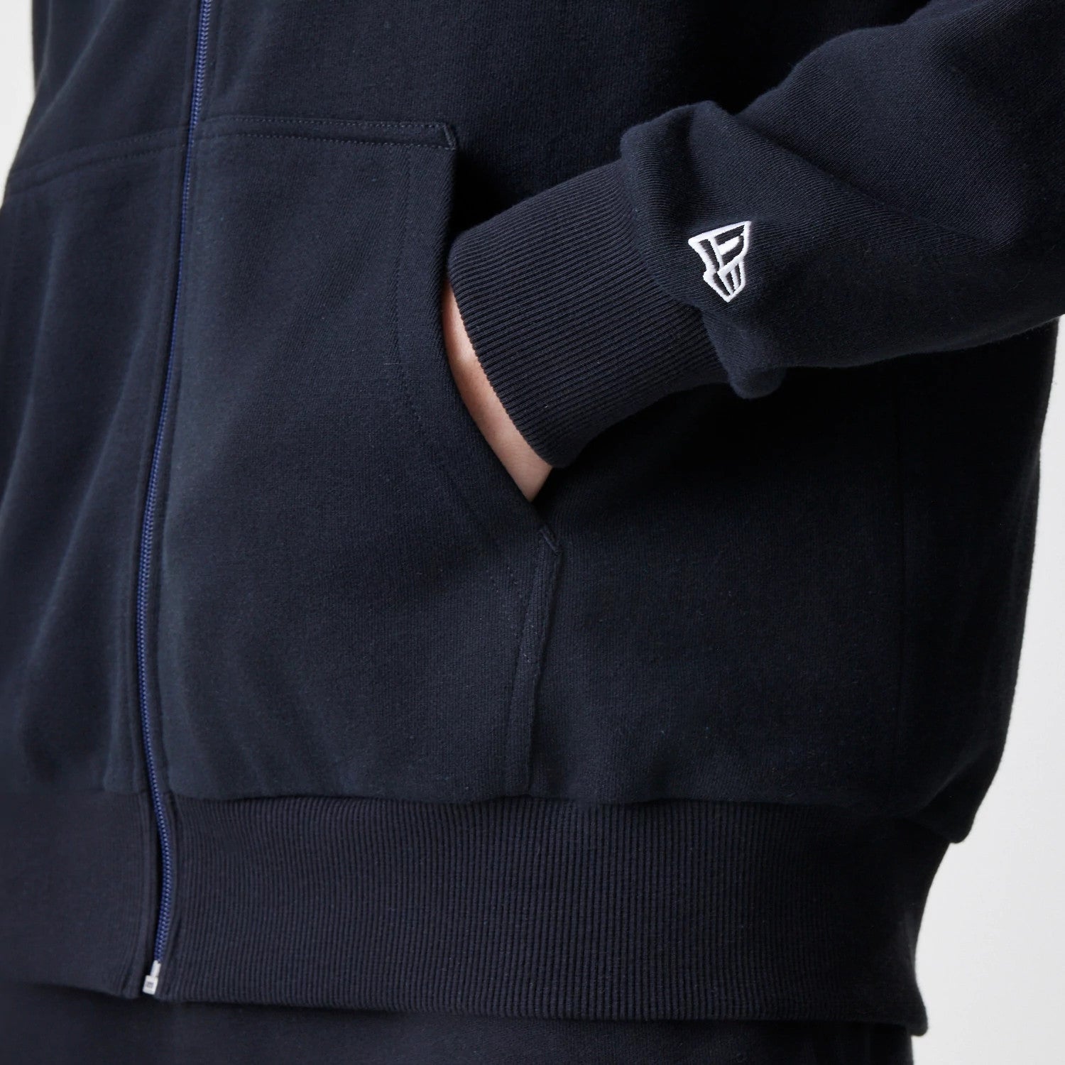 The Male model is wearing New Era Premium Essential Black Oversized Full Zip Hoodie 5
