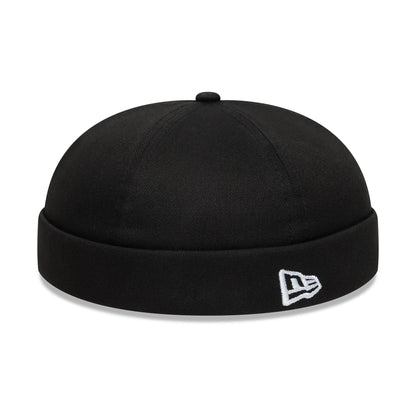 New Era Cotton Twill Black Docker Hat, three-quarter view showing the white embroidered New Era flag logo on the black rolled visor, with a cotton twill texture and a seamless rounded crown.
