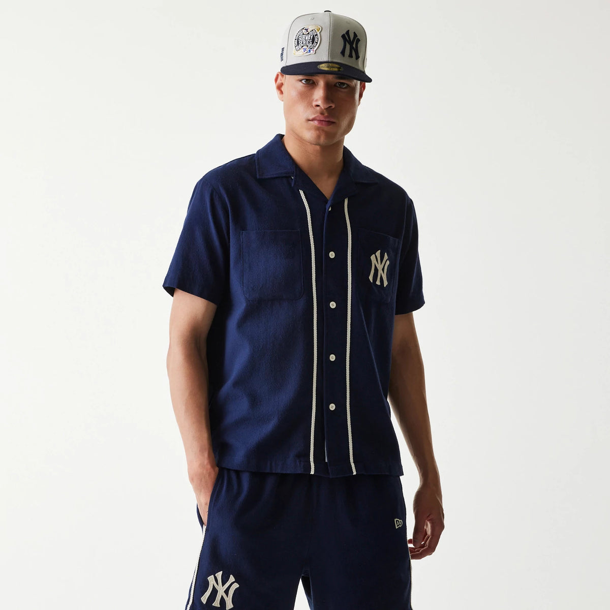 The Male model is wearing New York Yankees MLB Piping Navy Short Sleeve Shirt 1