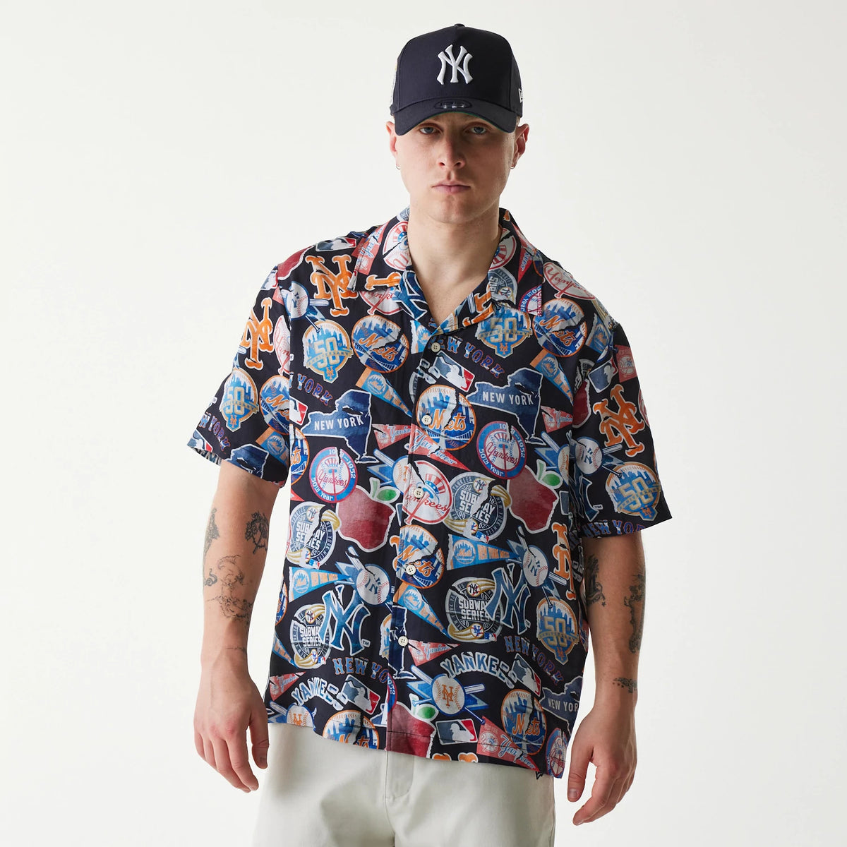 The Male model is wearing MLB Subway Series All Over Print Navy Short Sleeve Shirt 1
