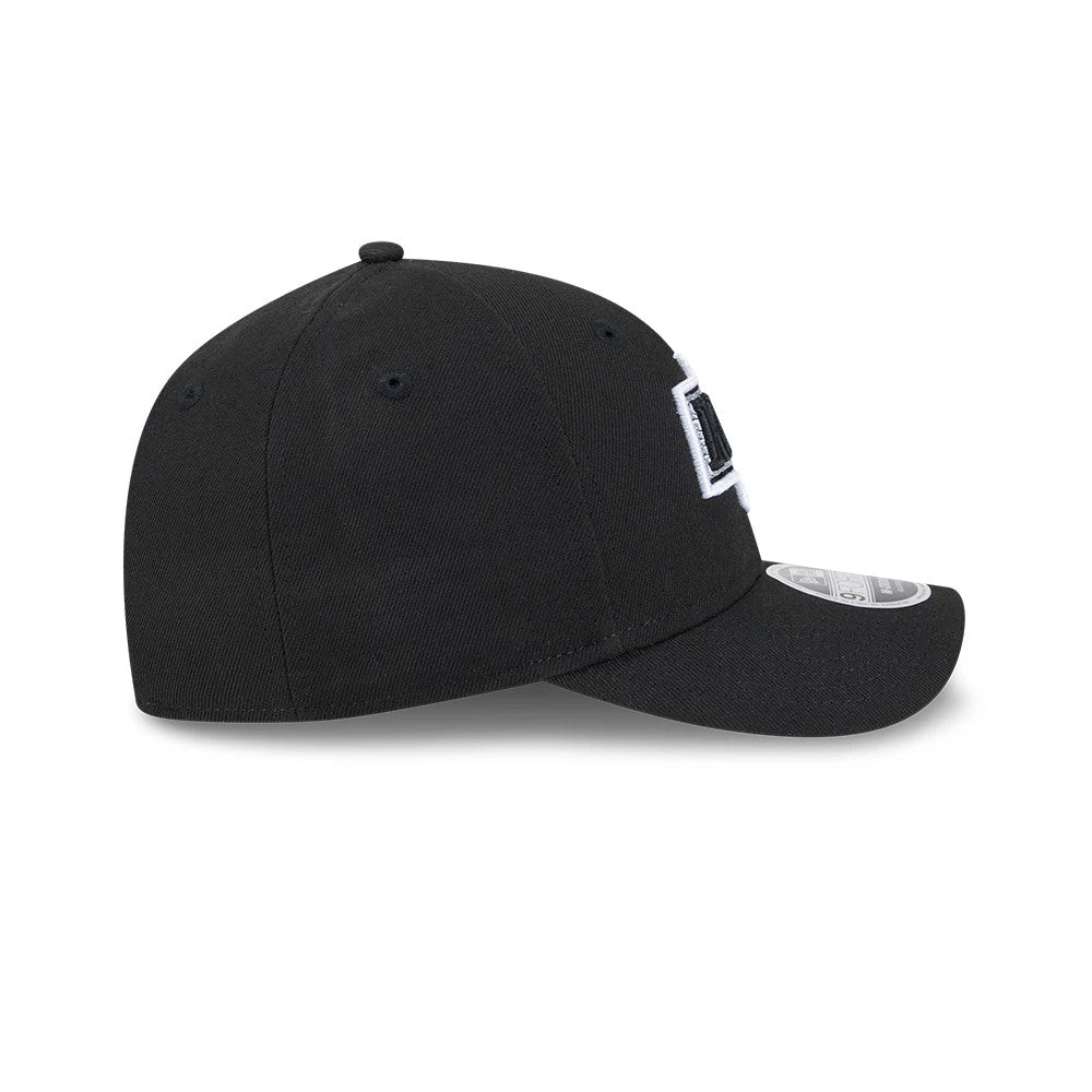 LA Kings NHL Team Black New Era 9FORTY M-Crown Adjustable Cap, side view showing the raised white embroidered logo on a structured black crown with a curved black visor and 9FORTY size sticker.