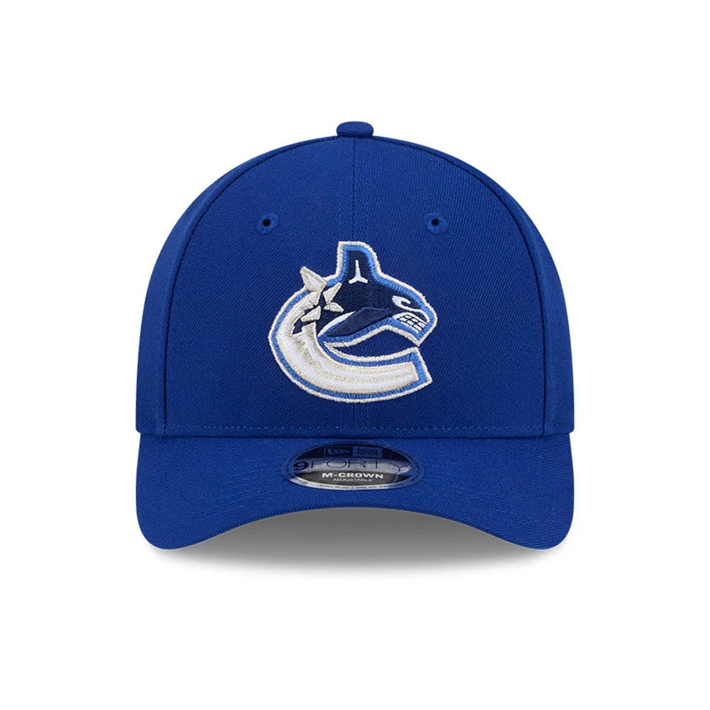 Vancouver Canucks NHL Team Blue New Era 9FORTY M-Crown Adjustable Cap, front view showing the raised embroidered Canucks logo on the structured blue crown, with a 9FORTY size sticker on the curved visor.