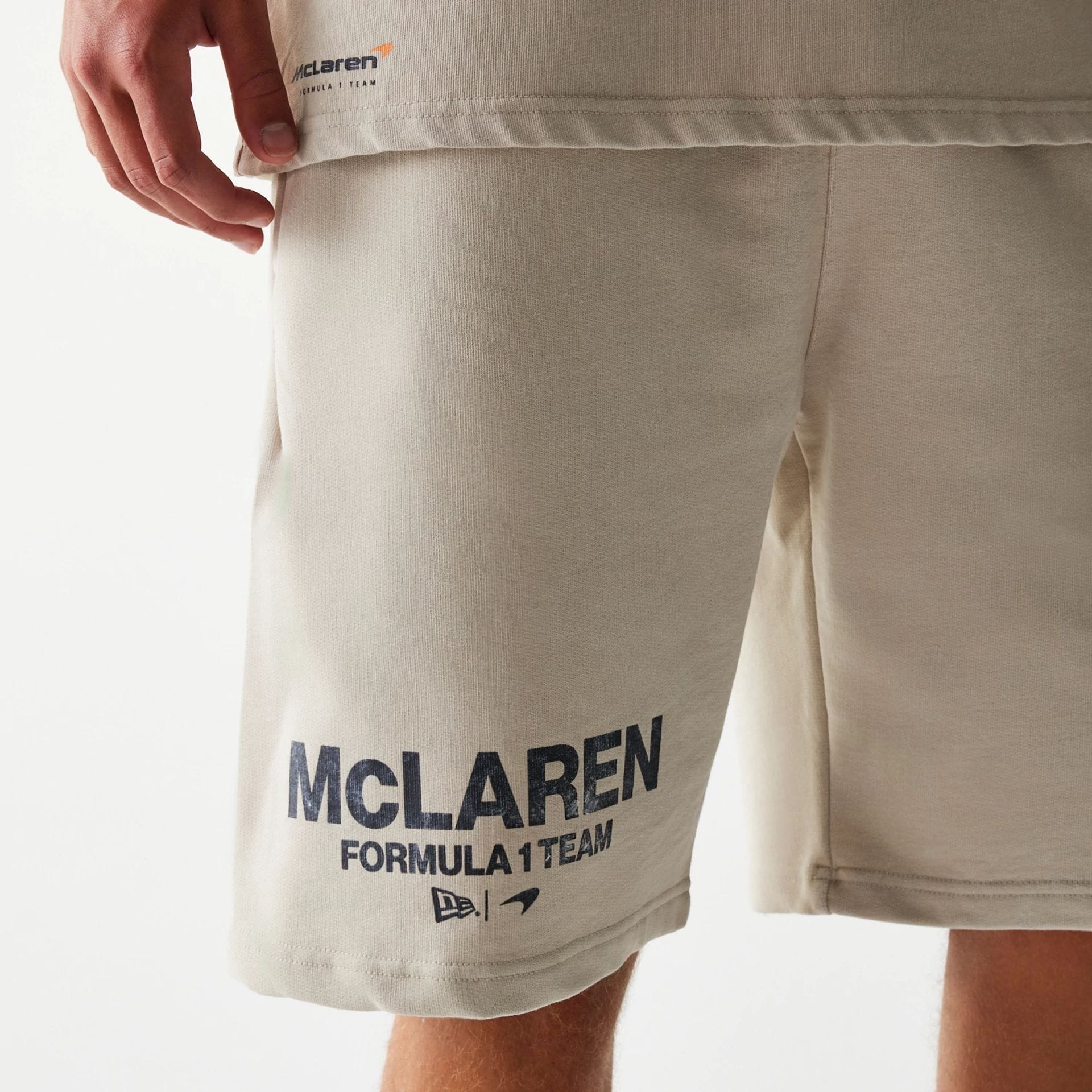 The Male model is wearing McLaren Racing Wordmark Light Beige Oversized Shorts 3