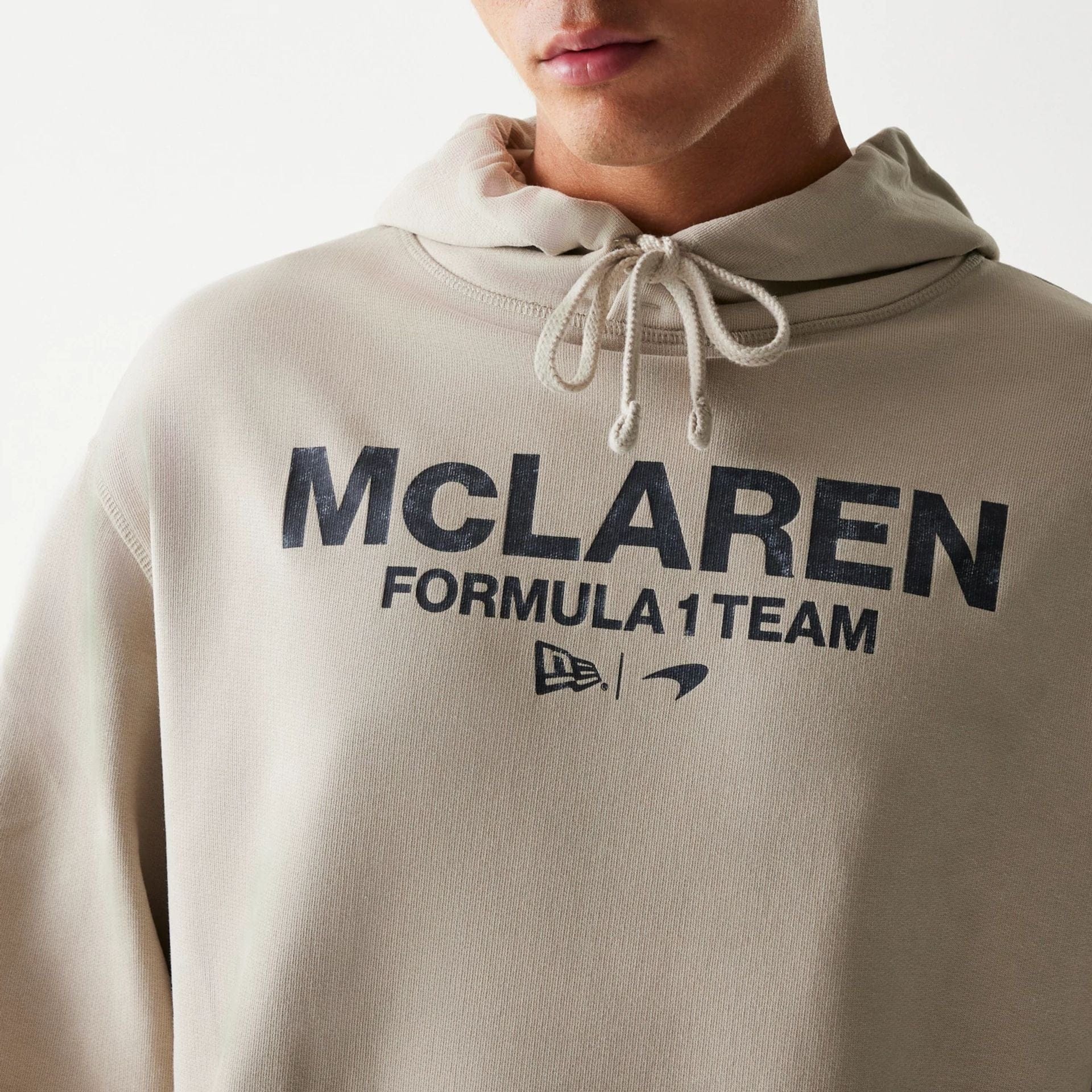 The Male model is wearing McLaren Racing Wordmark Light Beige Oversized Pullover Hoodie 3