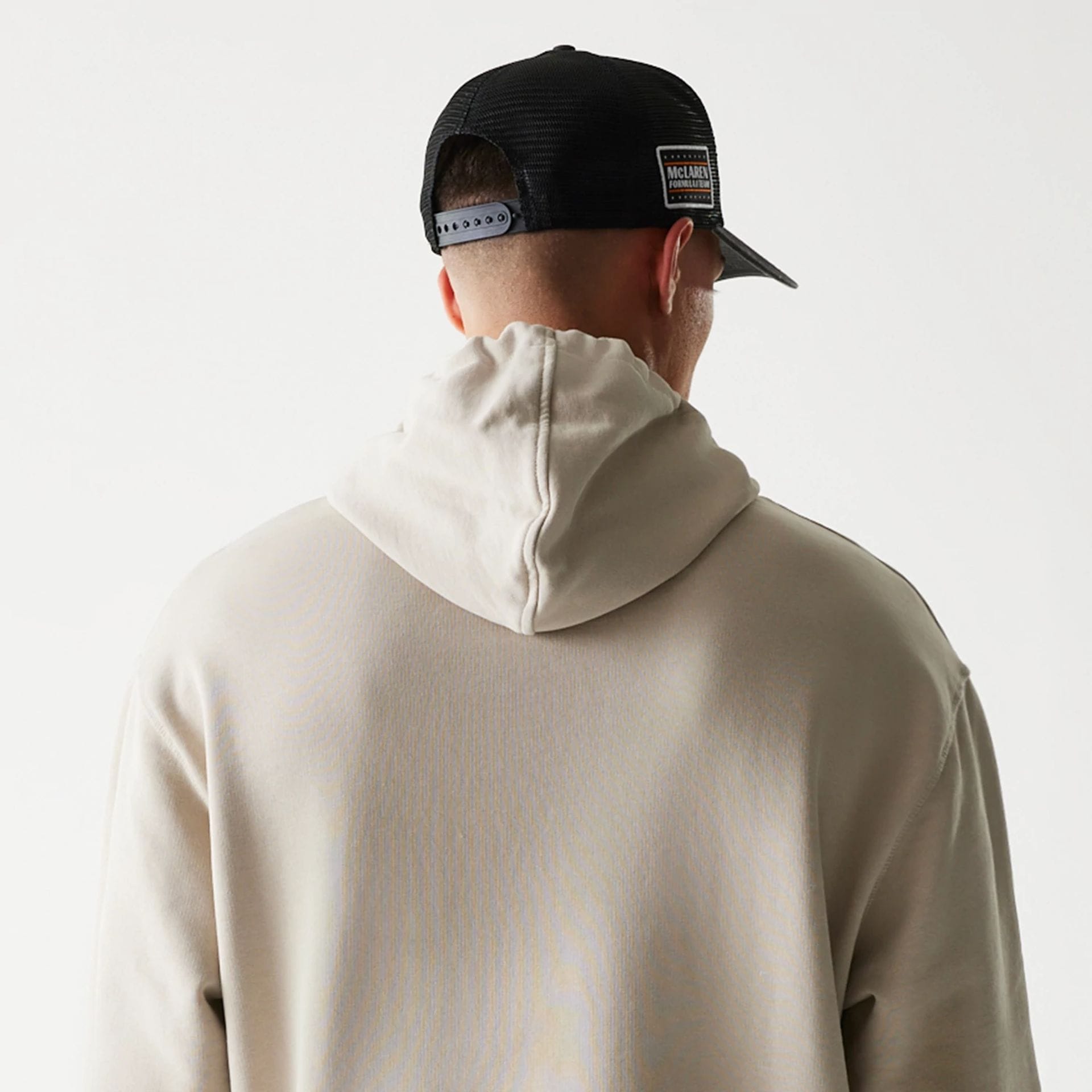 The Male model is wearing McLaren Racing Wordmark Light Beige Oversized Pullover Hoodie 7