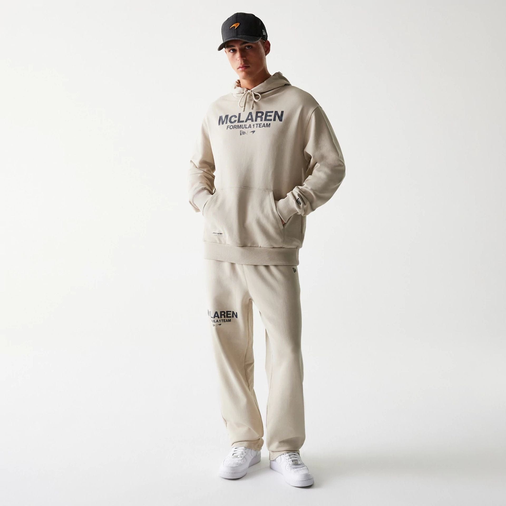 The Male model is wearing McLaren Racing Wordmark Light Beige Oversized Pullover Hoodie 8