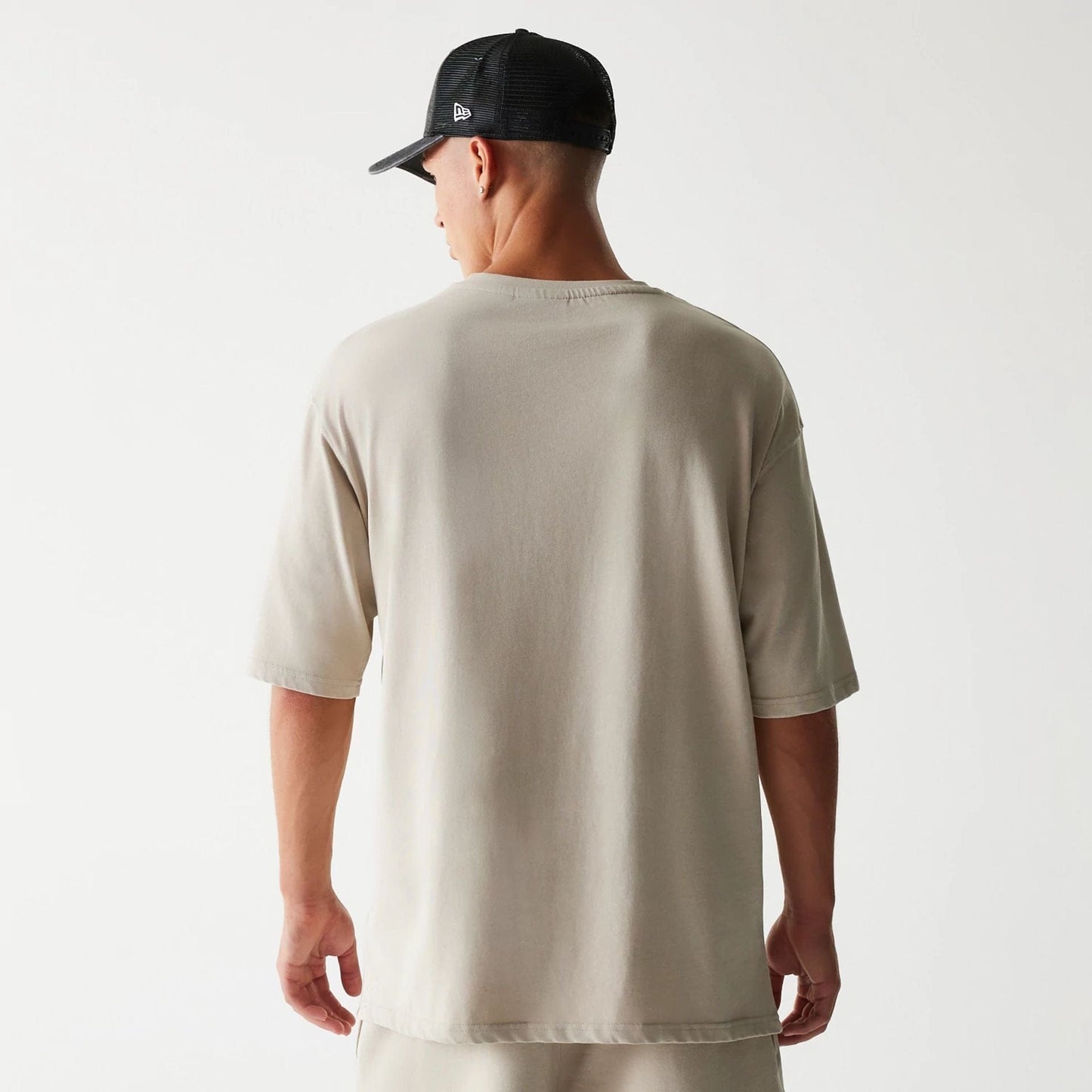 The Male model is wearing McLaren Racing Wordmark Light Beige Oversized T-Shirt 2