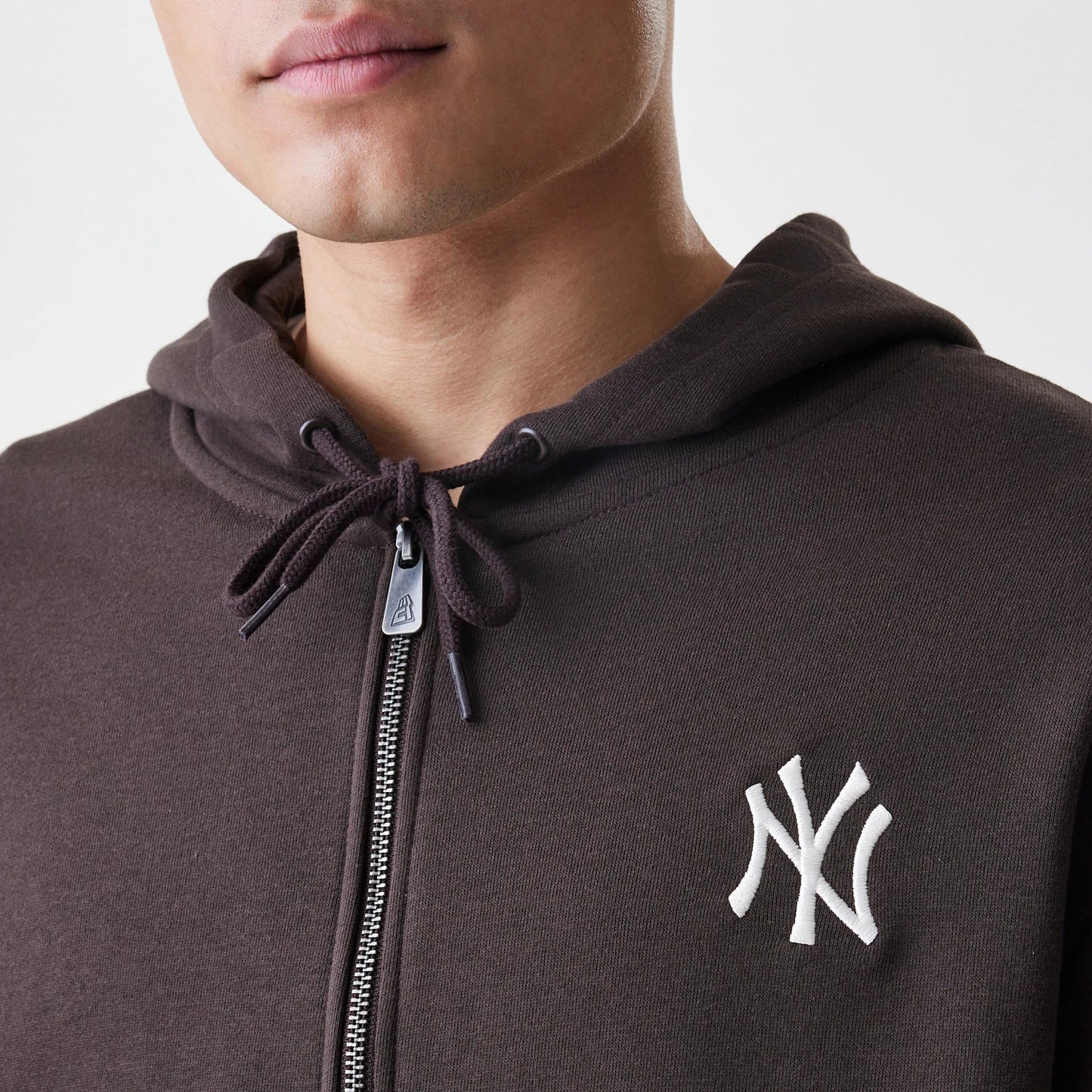 The Male model is wearing New York Yankees MLB Midi League Essential Dark Brown Full Zip Hoodie 6