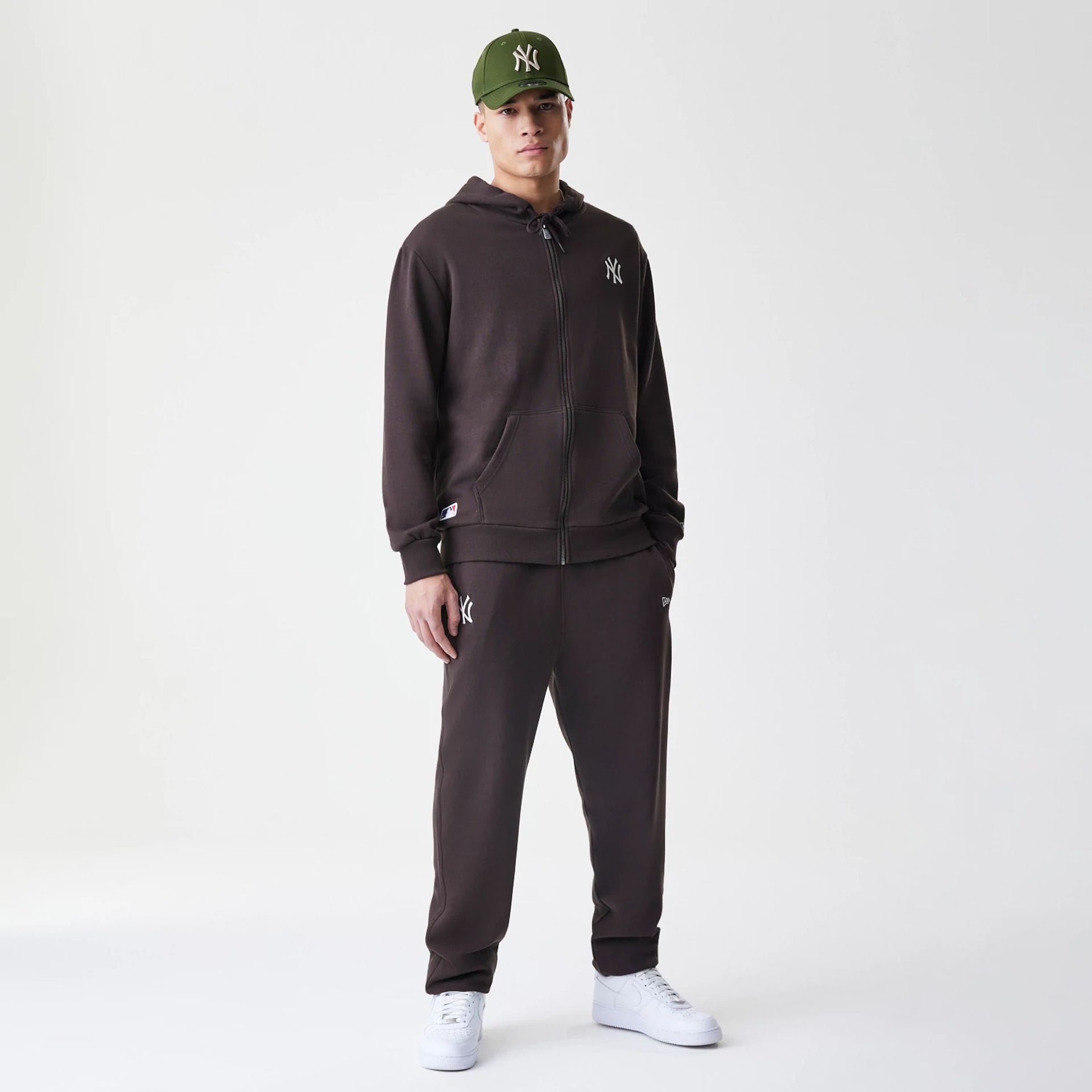 The Male model is wearing New York Yankees MLB Midi League Essential Dark Brown Full Zip Hoodie 8