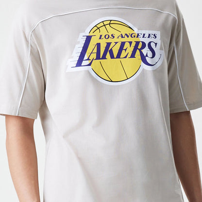 The Male model is wearing LA Lakers NBA Piping Light Beige Oversized T-Shirt  6
