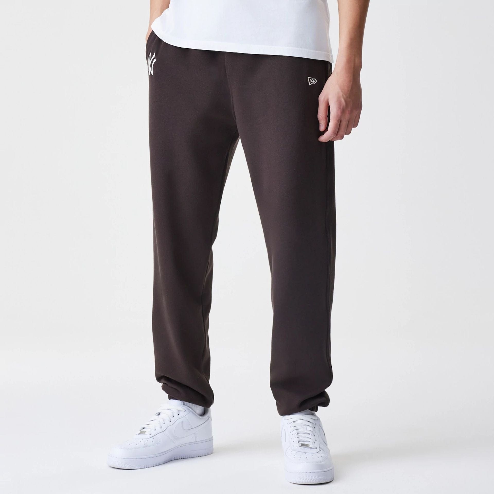 The Male model is wearing New York Yankees MLB Midi League Essential Dark Brown Joggers  1