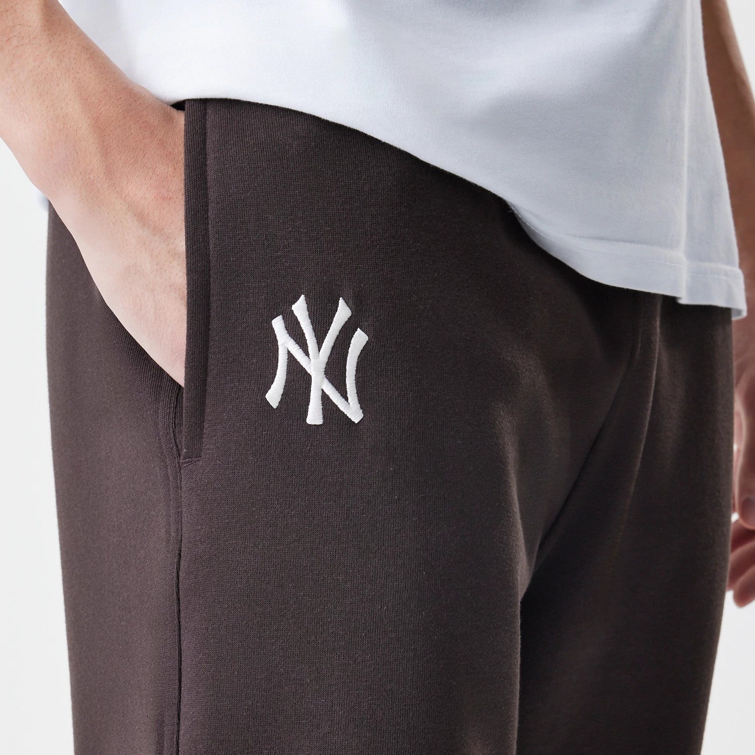 The Male model is wearing New York Yankees MLB Midi League Essential Dark Brown Joggers 3