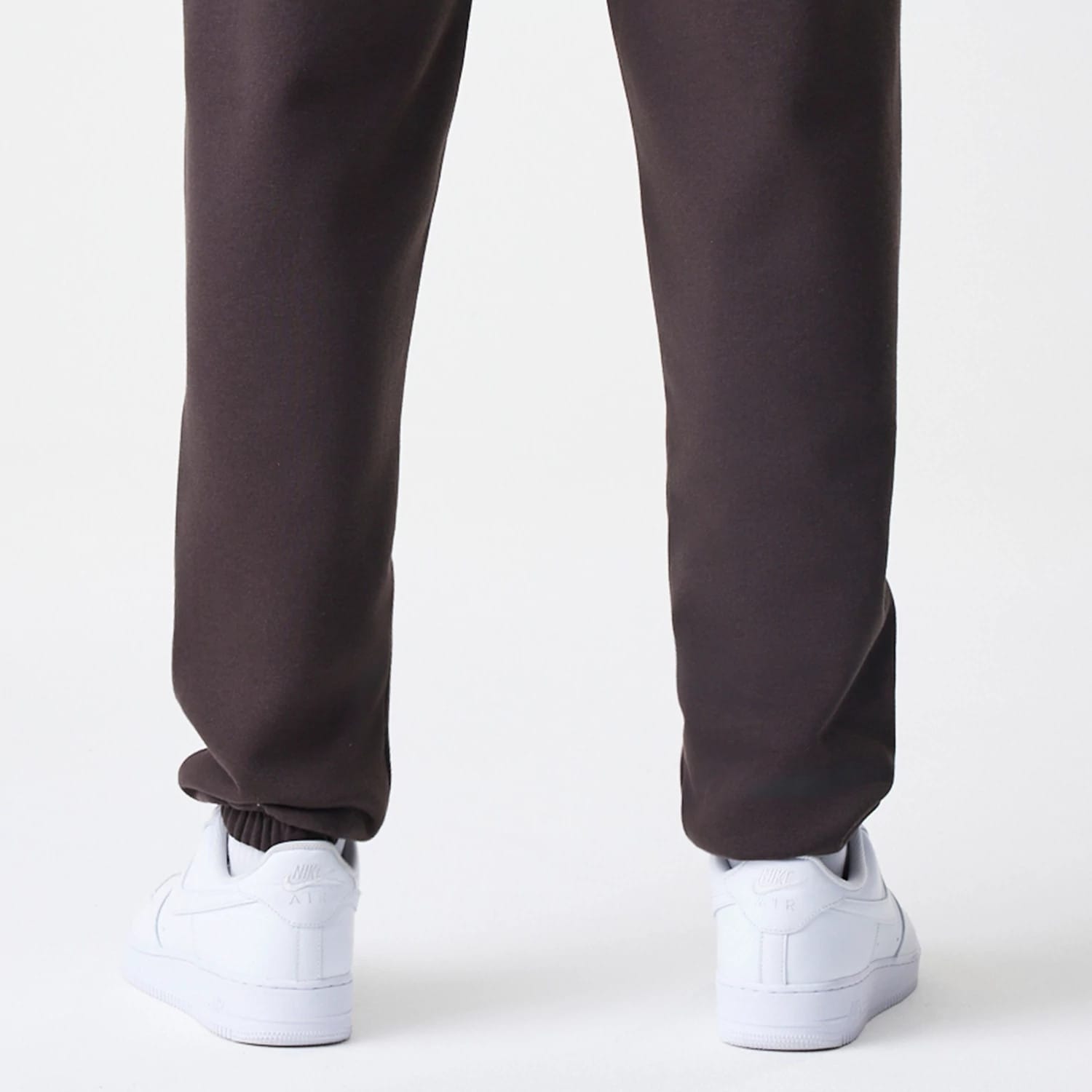 The Male model is wearing New York Yankees MLB Midi League Essential Dark Brown Joggers 4
