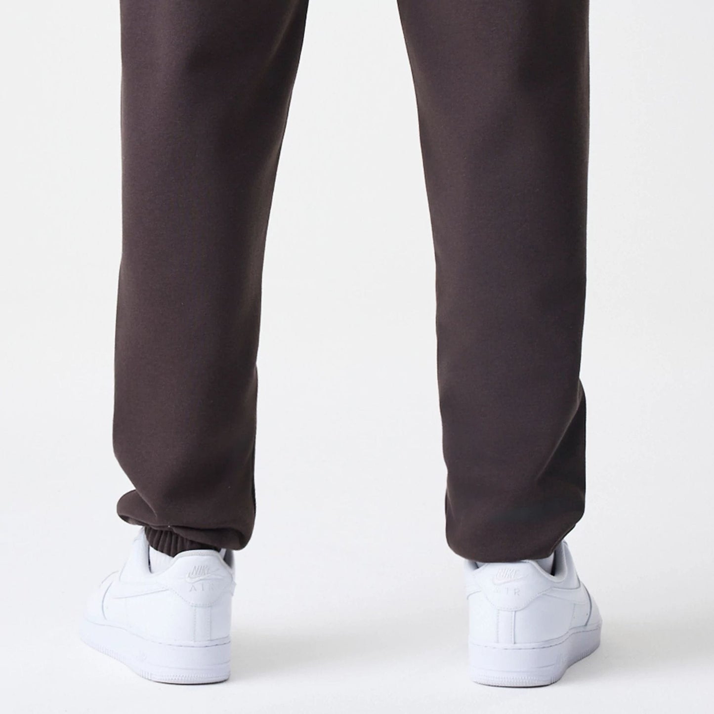 The Male model is wearing New York Yankees MLB Midi League Essential Dark Brown Joggers 4