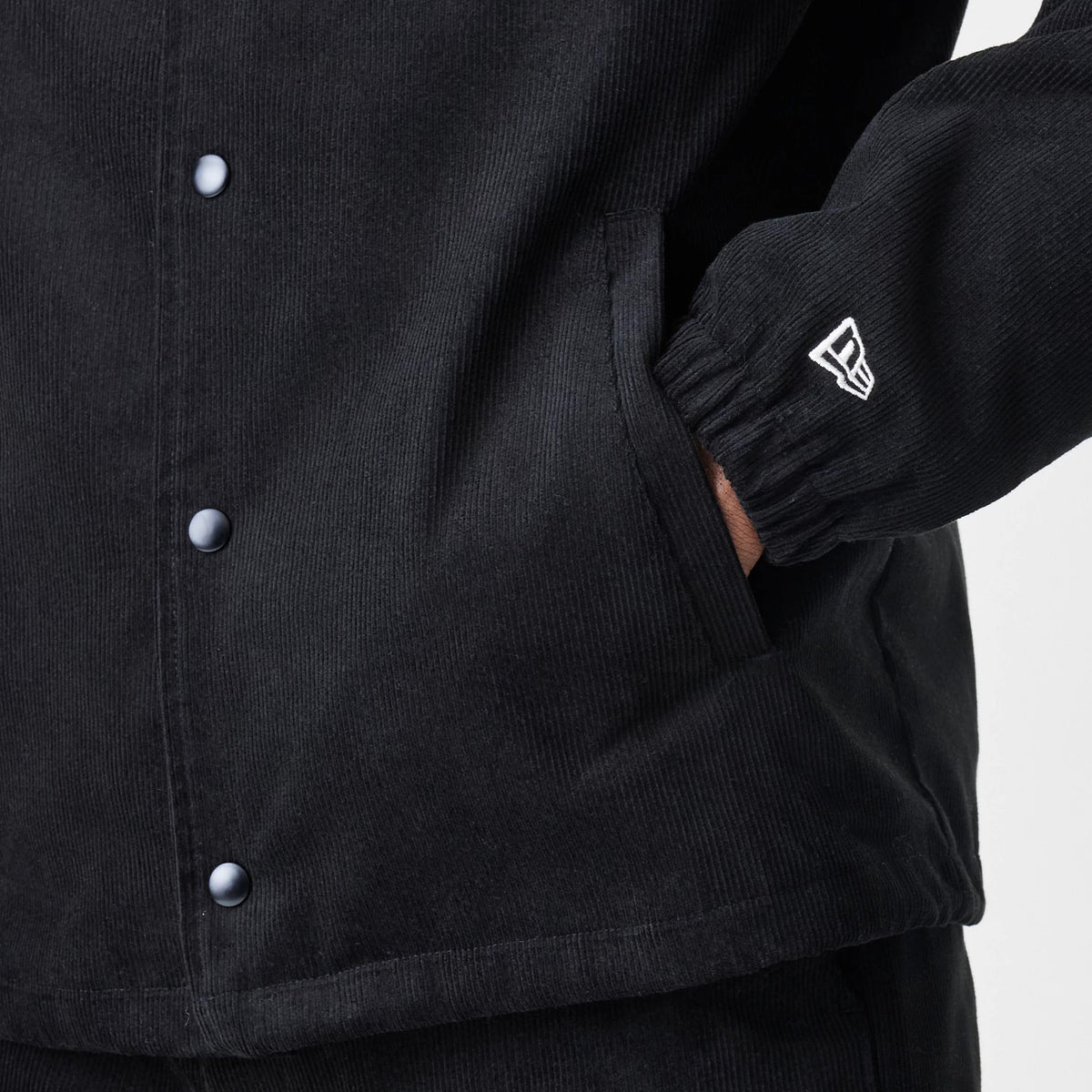 The Male model is wearing  New Era Cord Black Coaches Jacket 7