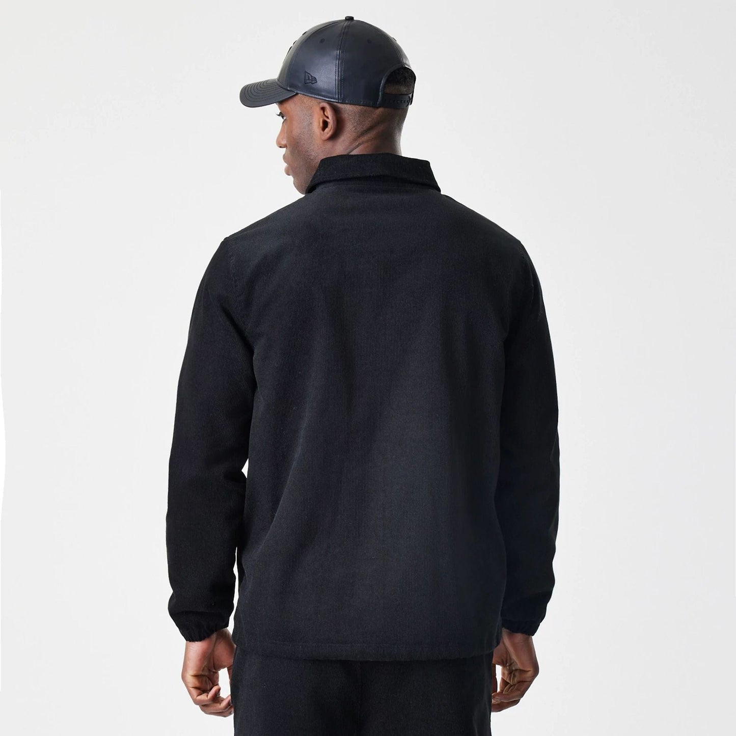 The Male model is wearing  New Era Cord Black Coaches Jacket  2
