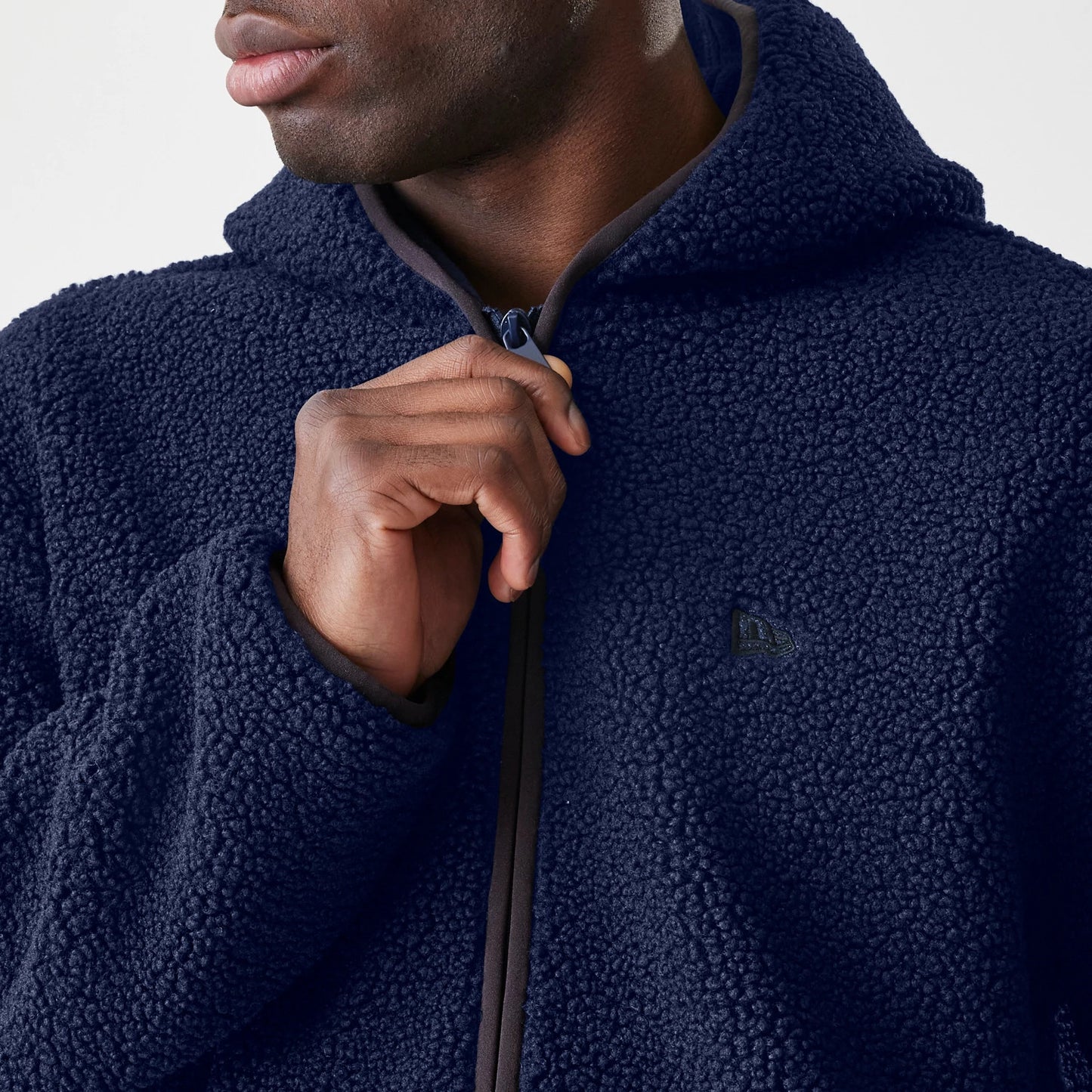 The Male model is wearing  New Era Navy Hooded Sherpa Jacket 5
