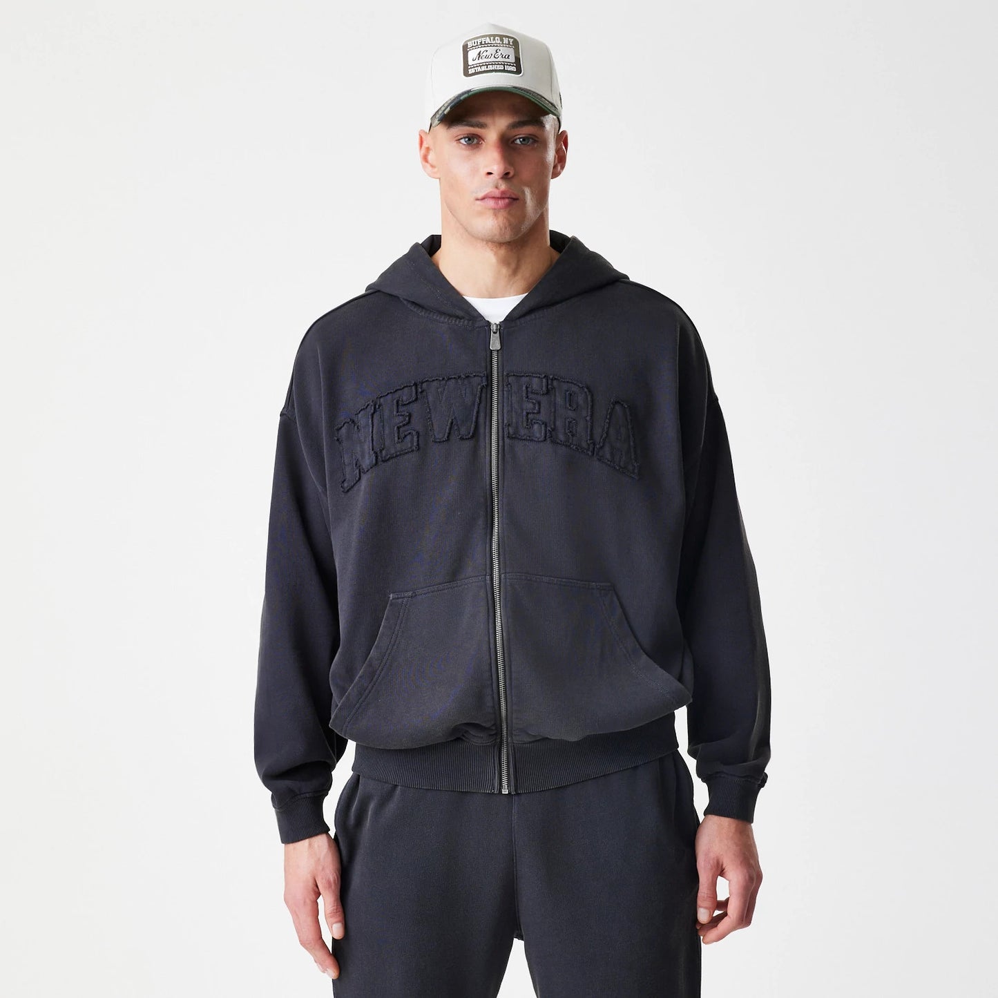 The Male model is wearing  New Era Washed Black Oversized Full Zip Hoodie 3