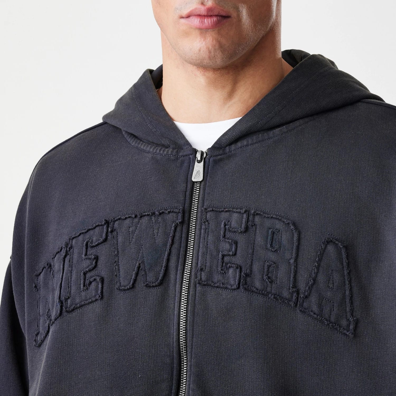 The Male model is wearing  New Era Washed Black Oversized Full Zip Hoodie 5