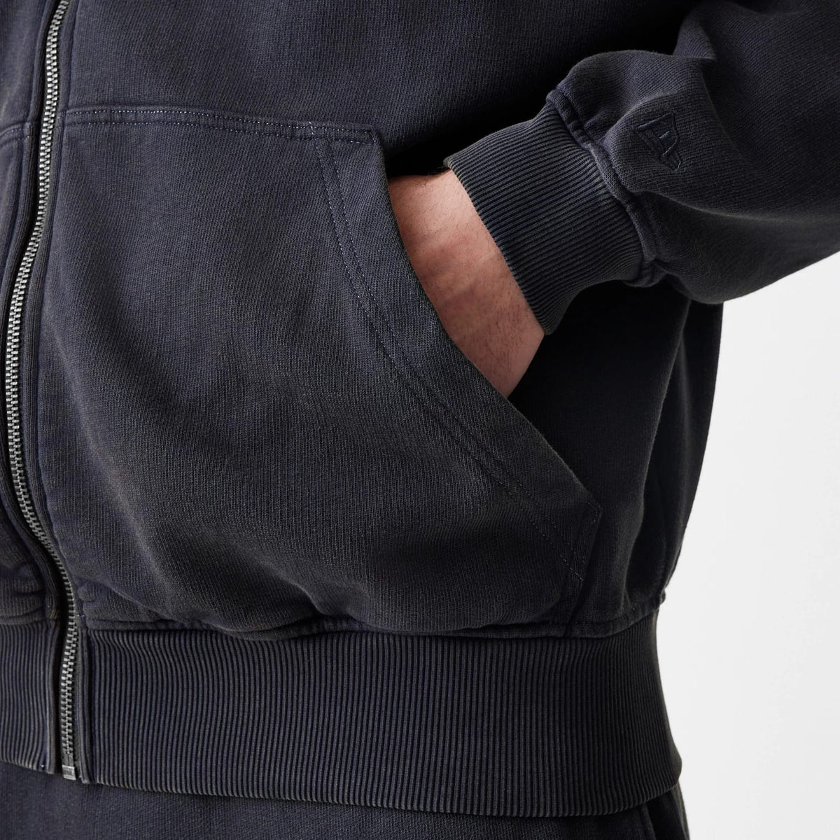 The Male model is wearing  New Era Washed Black Oversized Full Zip Hoodie 7