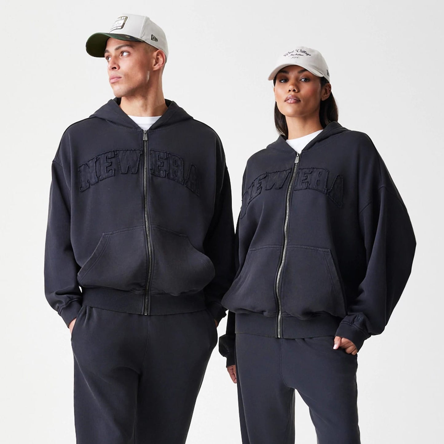 The Male model is wearing  New Era Washed Black Oversized Full Zip Hoodie 8